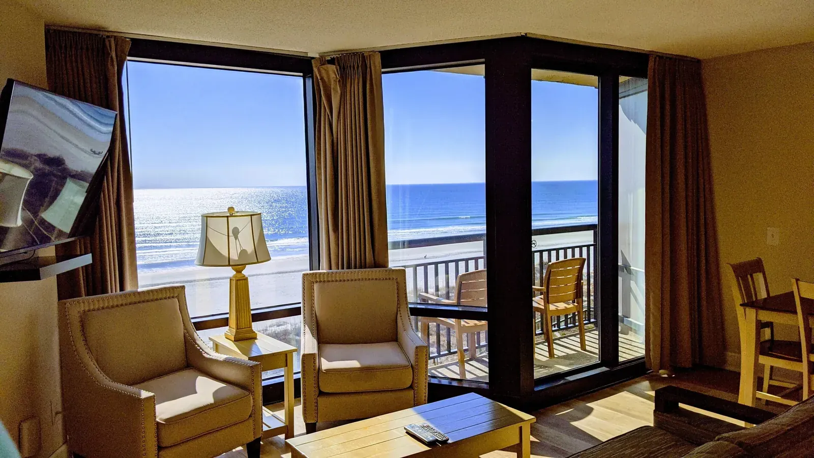 Living area and oceanfront balcony in a Shell Island Resort suite.